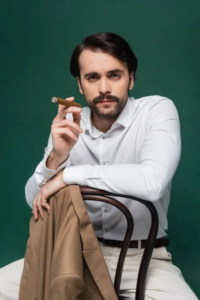 Man Mustache Holding Cigar Sitting Chair Dark Green — Stock Photo, Image
