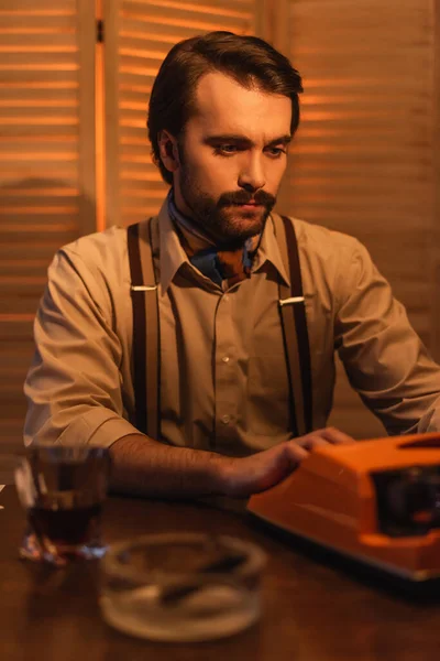 Journalist Mustache Using Retro Typewriter Machine Blurred Glass Brandy — Stock Photo, Image