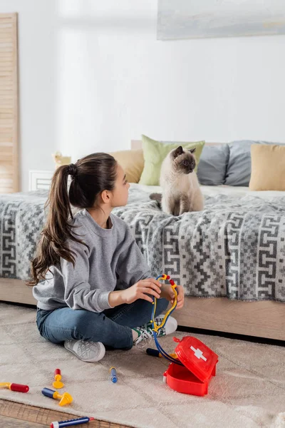 Girl Sitting Floor Toy Medical Set Fluffy Cat Bed — Stock Photo, Image