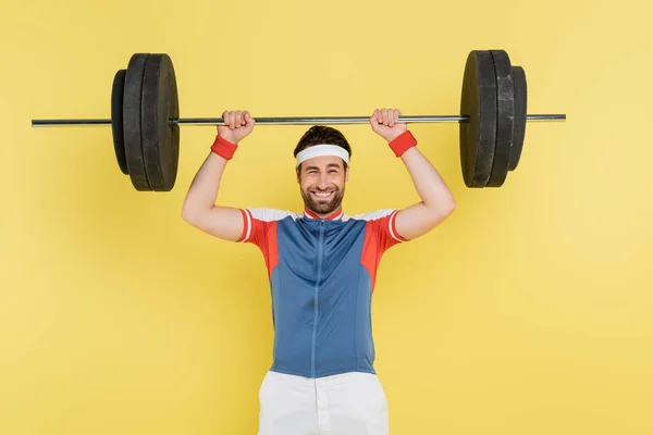 Positive Sportsman Lifting Barbell Isolated Yellow — Stock Photo, Image