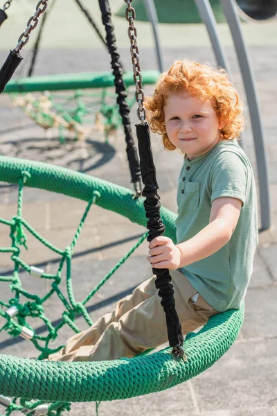 Curly Boy Looking Camera While Having Fun Hammock Amusement Park — Stock Photo, Image