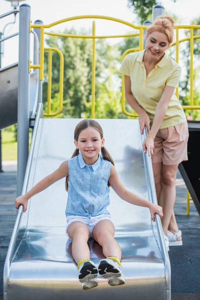 Girl Slide Smiling Camera While Spending Time Mom Amusement Park — Stock Photo, Image