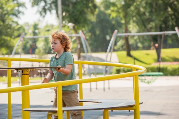 Curly Boy Having Fun Carousel Summer Park — Stock Photo, Image