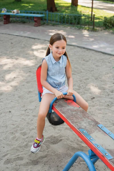 Smiling Girl Shorts Riding Seesaw Summer Park — Stock Photo, Image