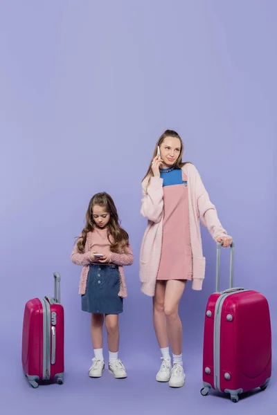 Comprimento Total Mãe Filho Usando Smartphones Perto Bagagem Roxo — Fotografia de Stock