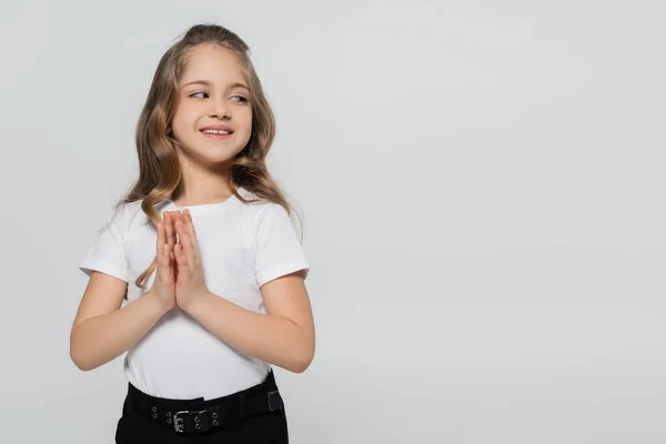 Positive Girl Praying Hands Smiling Looking Away Isolated Grey Stock Picture