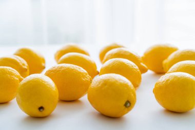 Fresh lemons with light on white background 