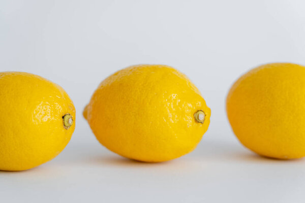 Close up view of juicy lemons on white surface 