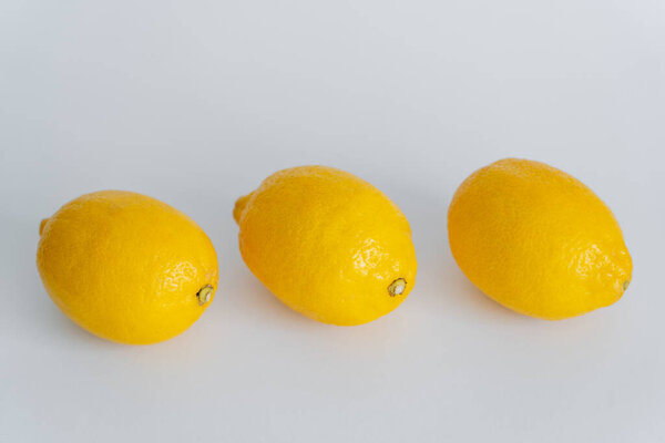 High angle view of yellow lemons on white surface 