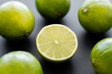 Close up view of half of lime on black background 