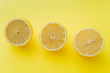 Sarı yüzeydeki taze limon parçalarının üst görüntüsü 