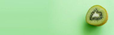 top view of kiwi fruit half on green, banner