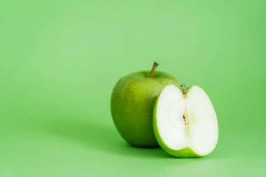organic and fresh apples on green background clipart