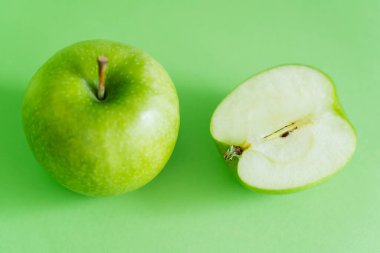 top view of delicious and fresh apples on green