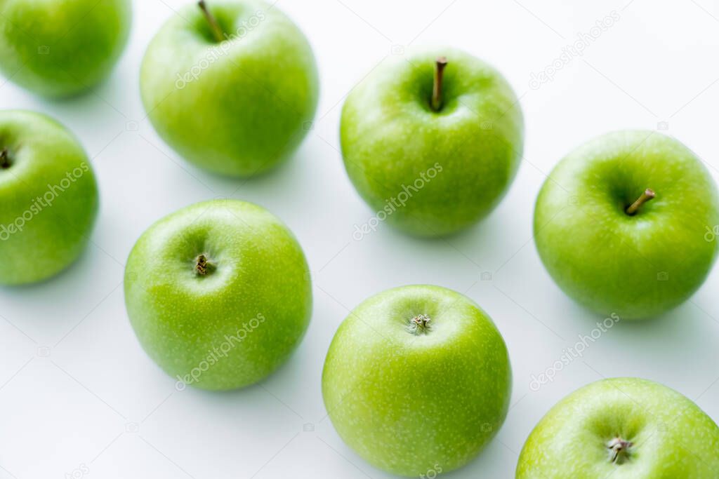 high angle view of delicious green apples on white