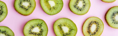 top view of sliced fresh kiwi on pink, banner