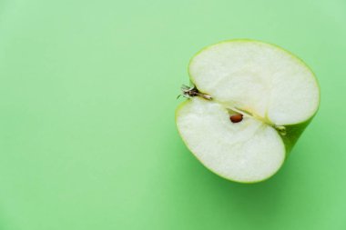 top view of fresh juicy apple half on green