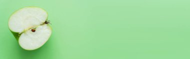 top view of fresh juicy apple half on green, banner