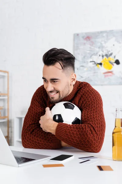 Cheerful Gambler Hugging Soccer Ball Laptop Credit Cards Beer — Φωτογραφία Αρχείου