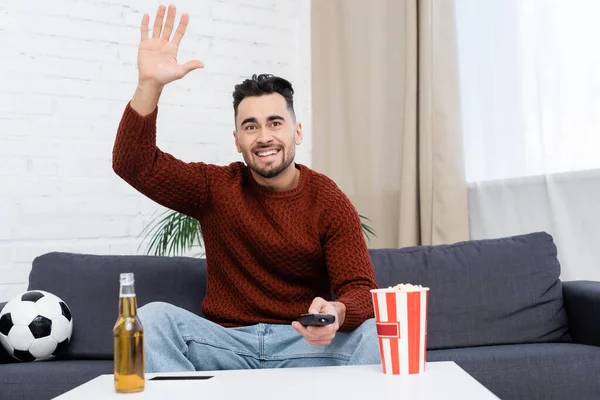 Cheerful Sports Fan Waving Hand While Watching Game Home Soccer — Stockfoto