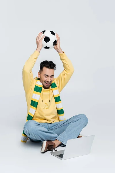 Joyful Bookmaker Soccer Ball Sitting Crossed Legs Laptop Grey — Stock Photo, Image