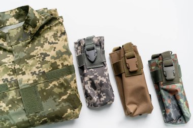 Top view of military bags and uniform on white background  clipart