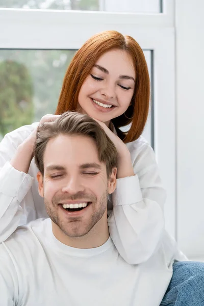 Positive Redhead Woman Touching Boyfriend Home — Stock Photo, Image