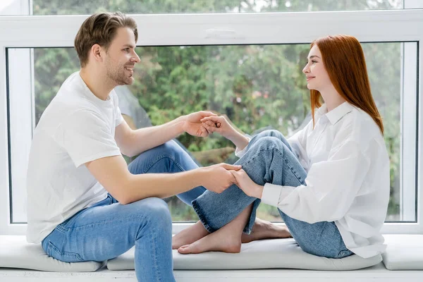 Side View Young Couple Holding Hands Windowsill Home — ストック写真