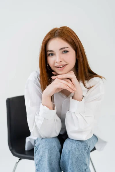 Pretty Redhead Woman Looking Camera While Sitting Blurred Chair Isolated — Stock Photo, Image