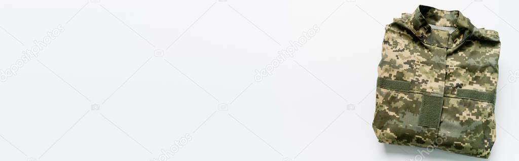 Top view of military uniform on white background with copy space, banner 