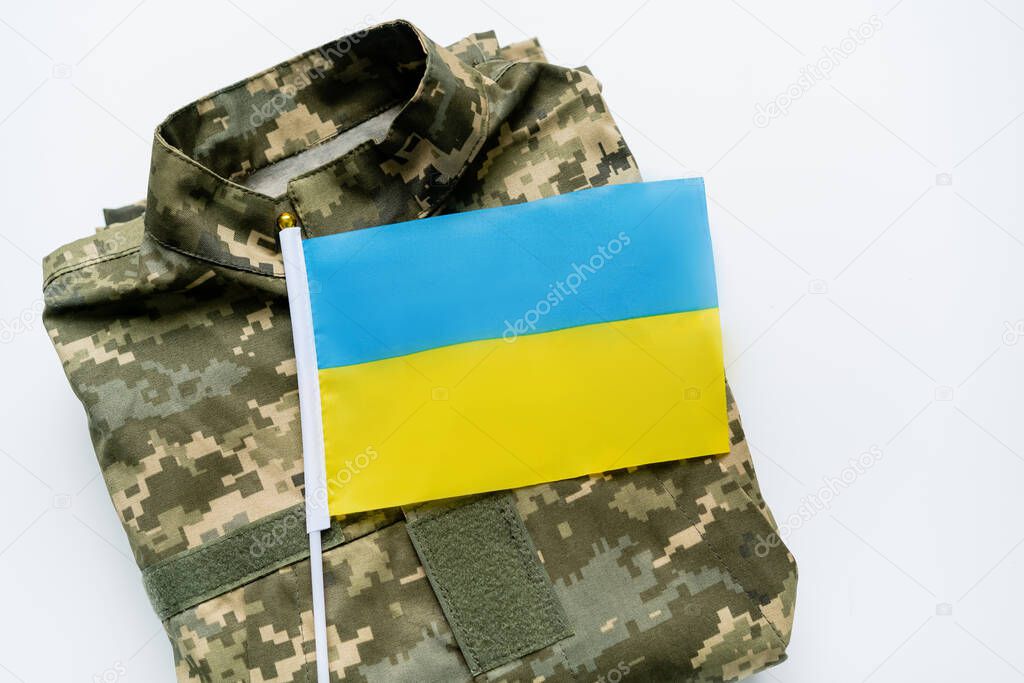 Top view of ukrainian flag on military uniform on white background 