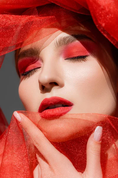 Portrait Pretty Woman Red Visage Closing Eyes Holding Cloth Isolated — стоковое фото