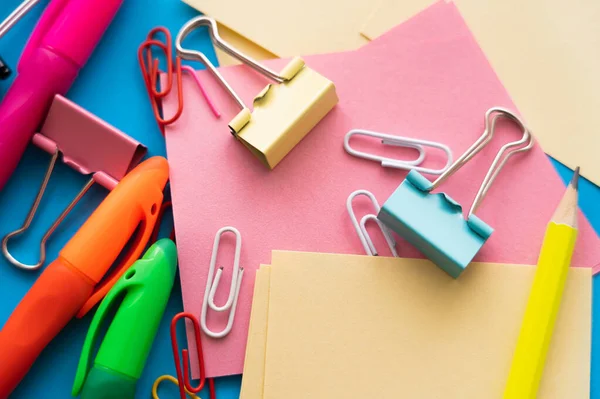 close up view of colorful paper clips and fold back clips on paper notes