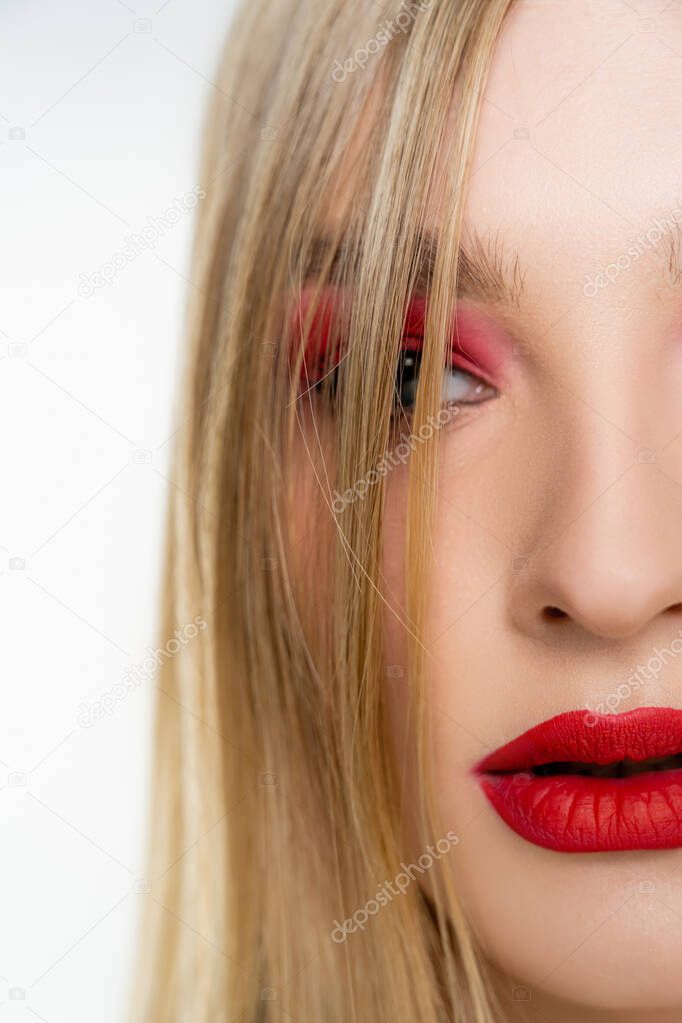 Close up view of fair haired model with red lips isolated on white