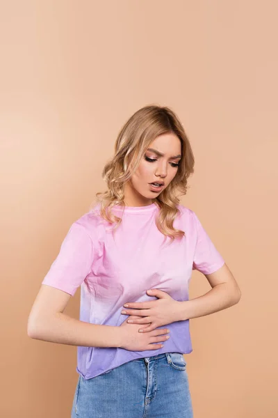 Displeased Woman Touching Belly While Suffering Abdominal Pain Isolated Beige — 스톡 사진