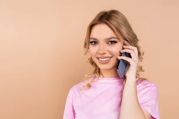 Cheerful Woman Smiling Camera While Talking Mobile Phone Isolated Beige — Stock Photo, Image