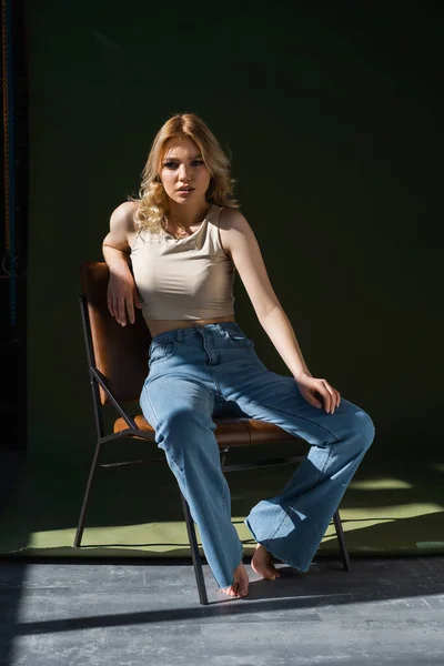 Full Length View Young Pretty Woman Sitting Chair Jeans Dark — Zdjęcie stockowe