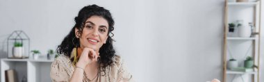 Gülümseyen çingene medyumu evdeki kameraya bakıyor. 