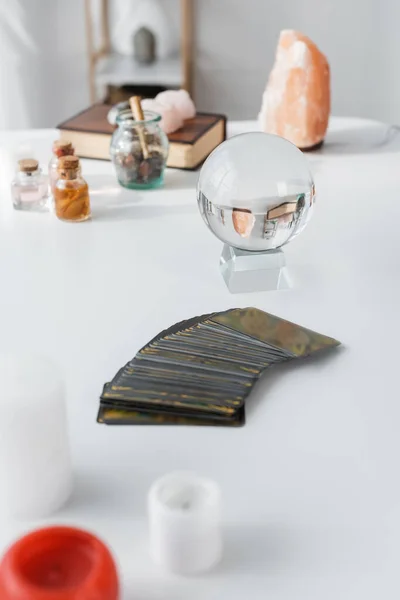 Tarot candles and magic orb on table