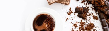 Top view of cup of coffee, waffles and brown chocolate on white background, banner  clipart