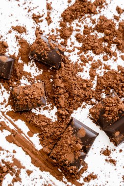 Top view of natural cocoa powder on chocolate on white background  clipart