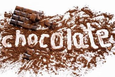 Top view of chocolate lettering in cocoa near bar on white background  clipart