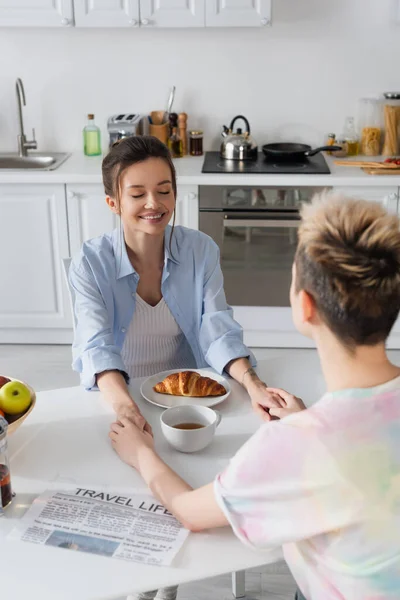 Bigender Couple Holding Hands Breakfast Travel Life Newspaper Kitchen — Stock Photo, Image