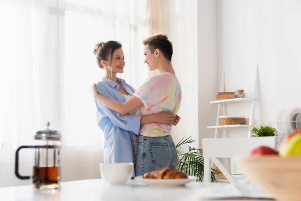 Happy Bigender Couple Embracing Kitchen Blurred Breakfast — Photo