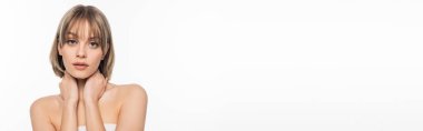young woman with bare shoulders touching neck isolated on white, banner