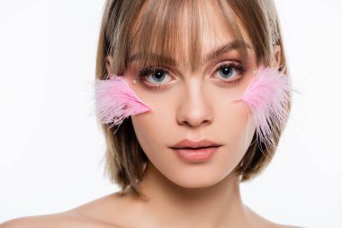 young woman with decorative elements in makeup and pink feathers on cheeks isolated on white clipart