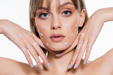 young model with creative heart shape elements in makeup isolated on white 