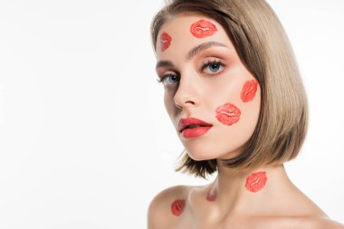 red kiss prints on cheeks and body of pretty young woman isolated on white
