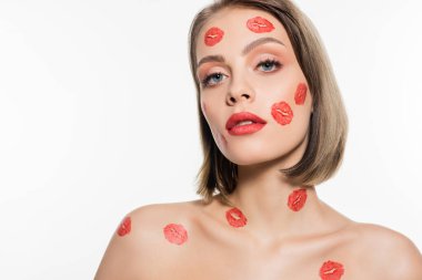 red kiss prints on cheeks and body of confident young woman isolated on white