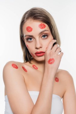 red kiss prints on cheeks and body of pretty woman isolated on white